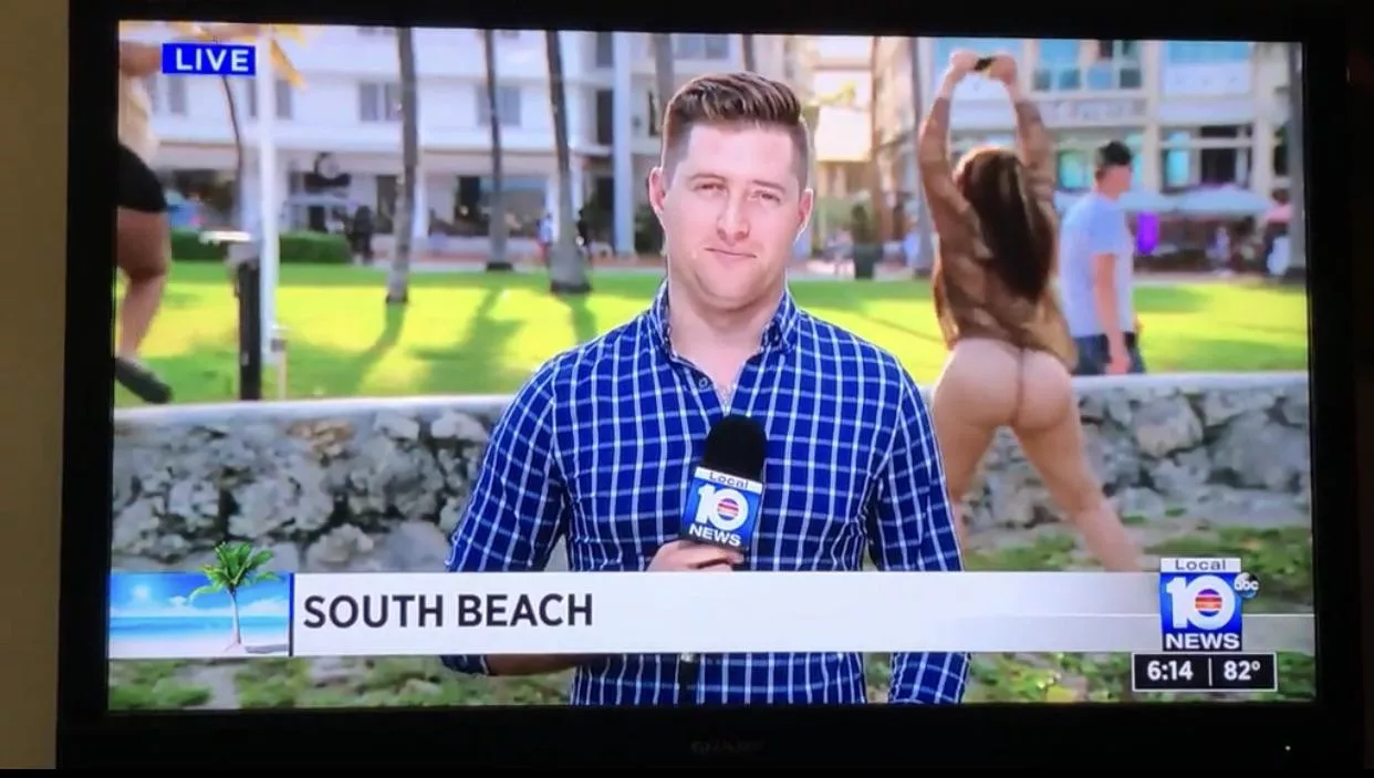 A sexy streaker shaking her ass behind a reporter live on the air.