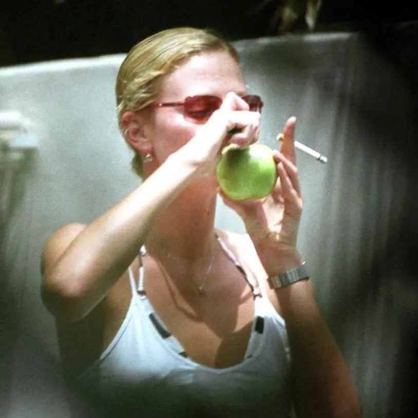 Charlize Theron smoking a cigarette…and an apple 😉