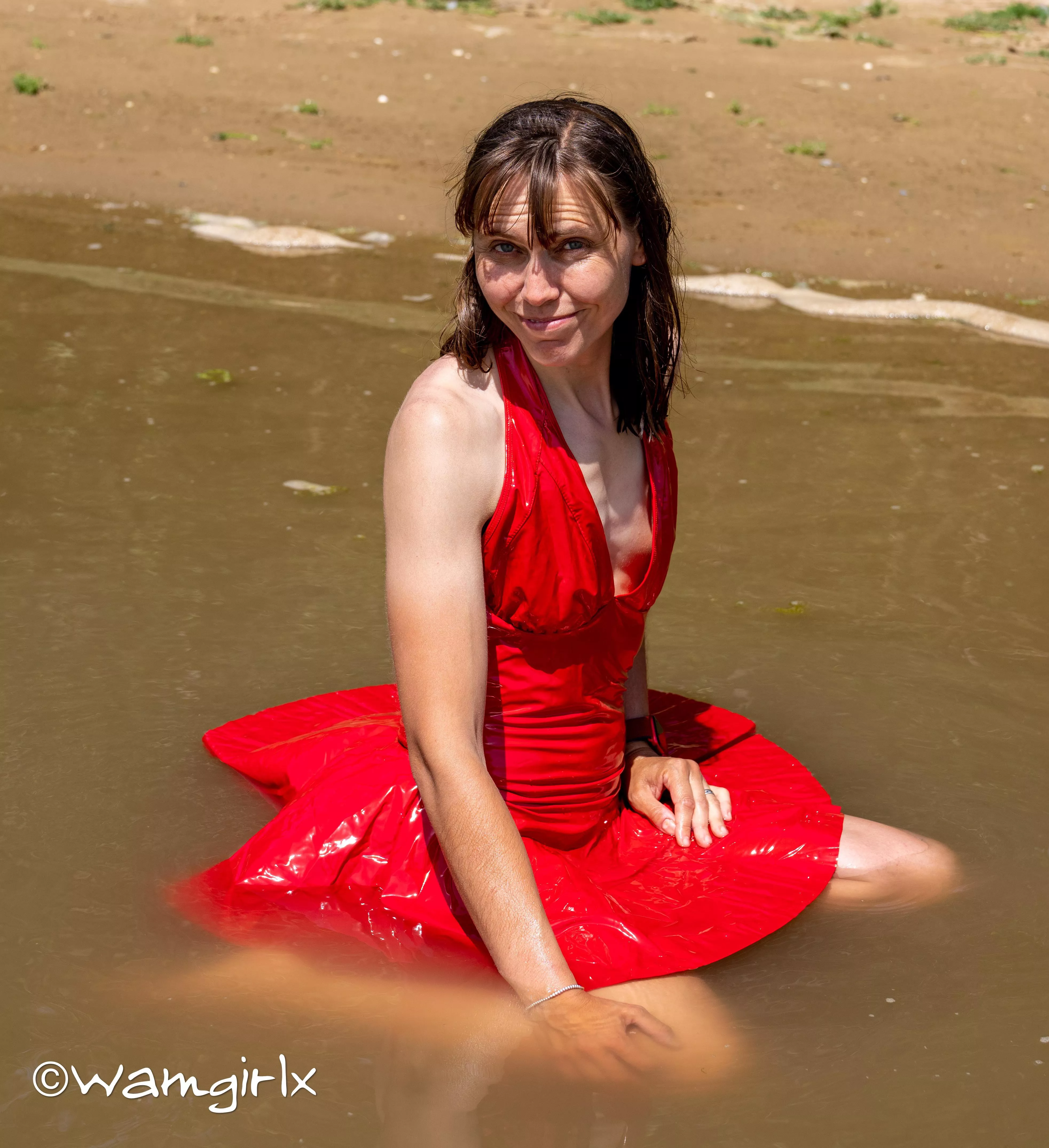 I just love this pic so much taken from my new wetlook video. I loved the way my red dress floated on top of the water.