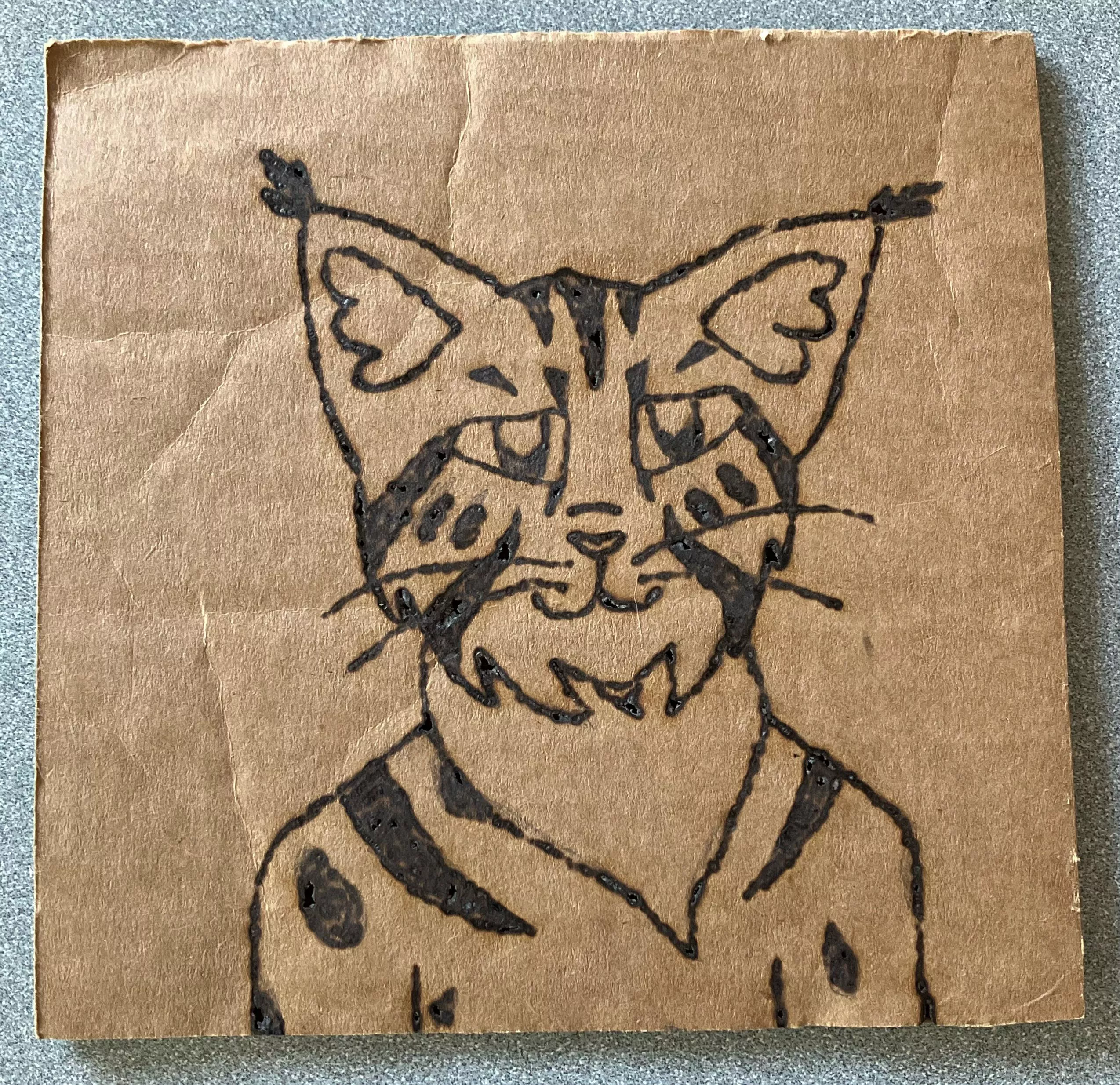 My fursona burned into cardboard (I used a magnifying glass and the sun, nothing fancy)
