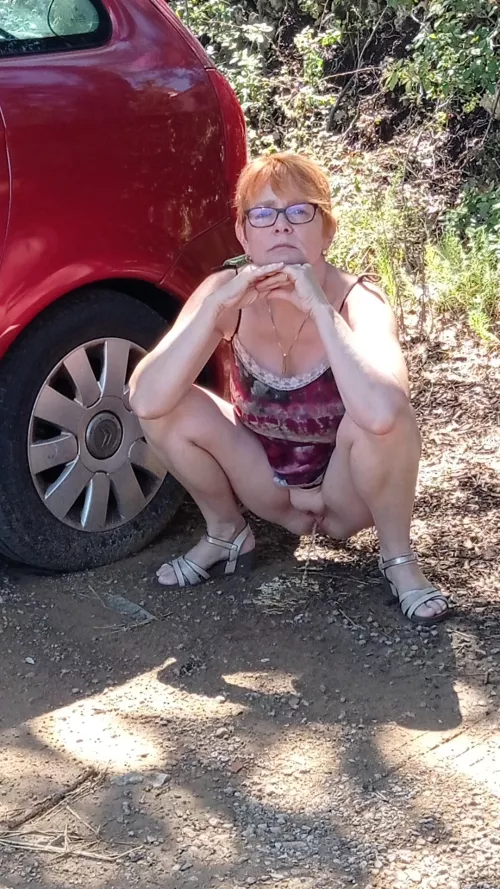 the redhead glasses MILF with shaved pussy and big tits pee on public car place
