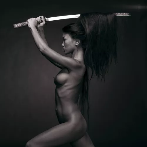 Asian woman wielding katana