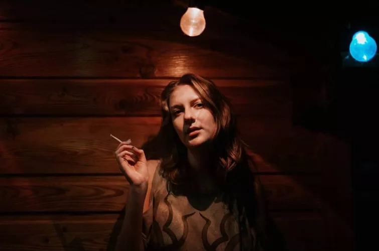 Girl next door smoking at a restaurant