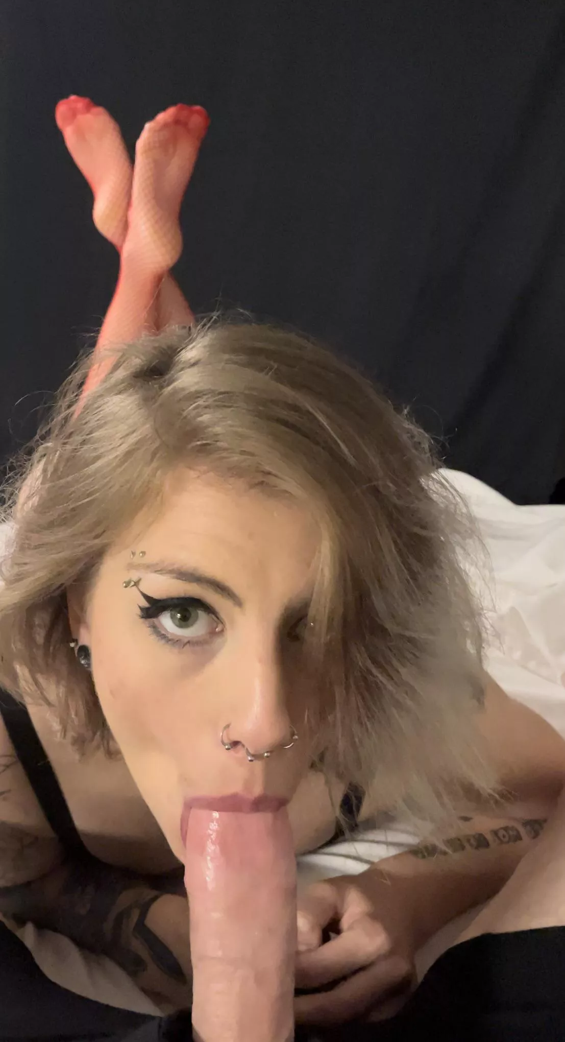 First still frame from video we just shot. Red fishnet legs crossed while she lays on the bed and swallows my load.