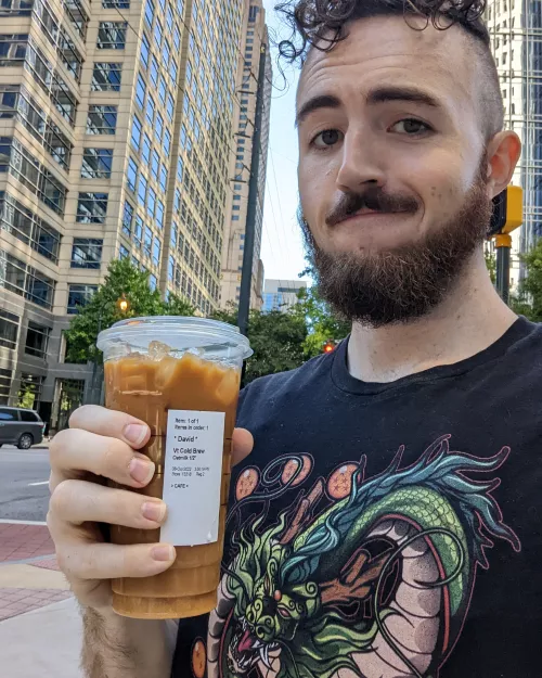 Not me showing up to Pride with a venti cold brew with oatmilk and a harness under my DBZ t-shirt