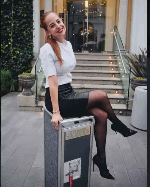 Sexy redhead in black pantyhose