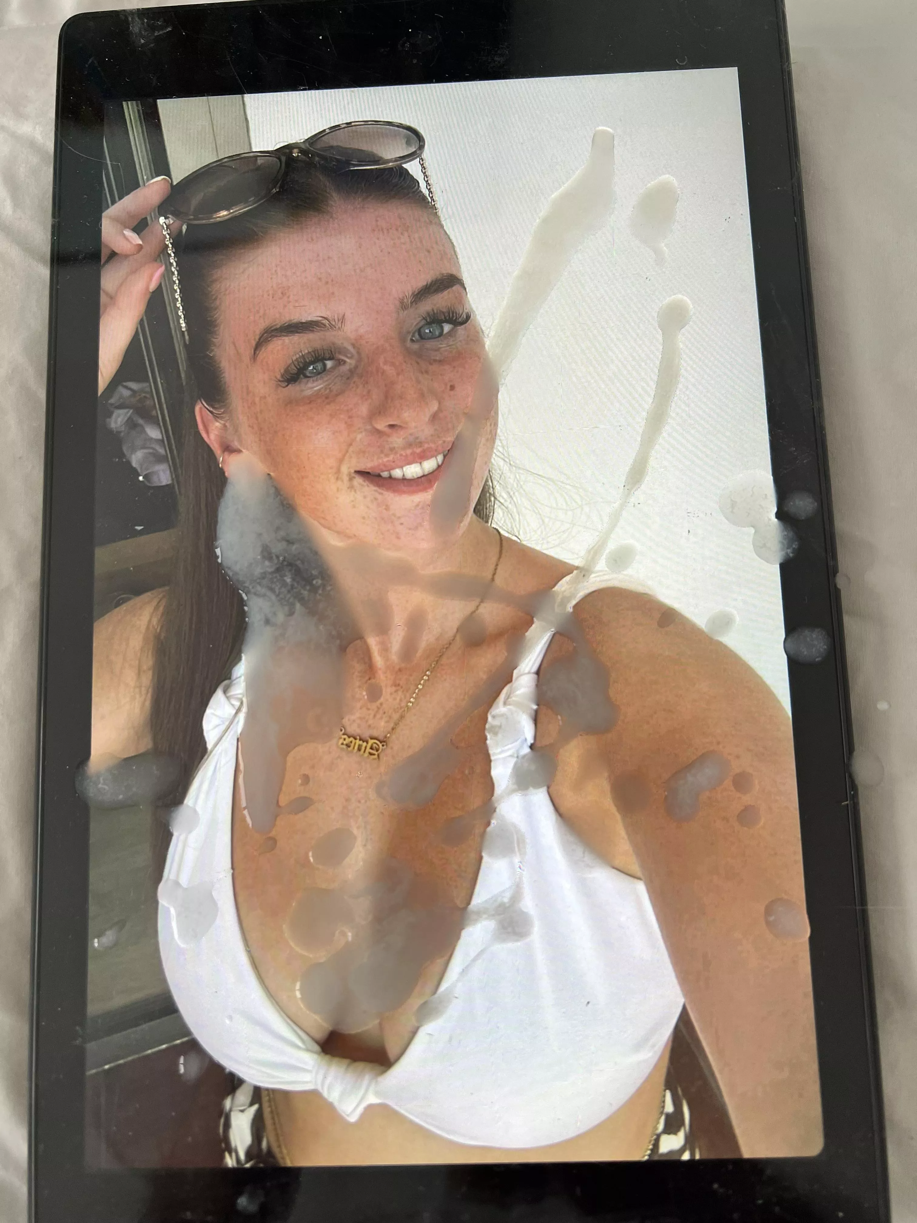 Spraying her freckles!