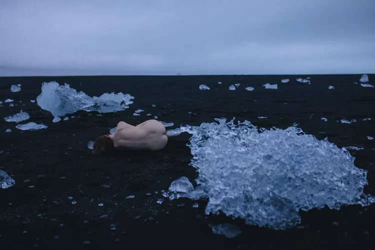 Alexandra Rachok by Anastasia Mihaylova - lying on the volcanic sand next to the ice floes