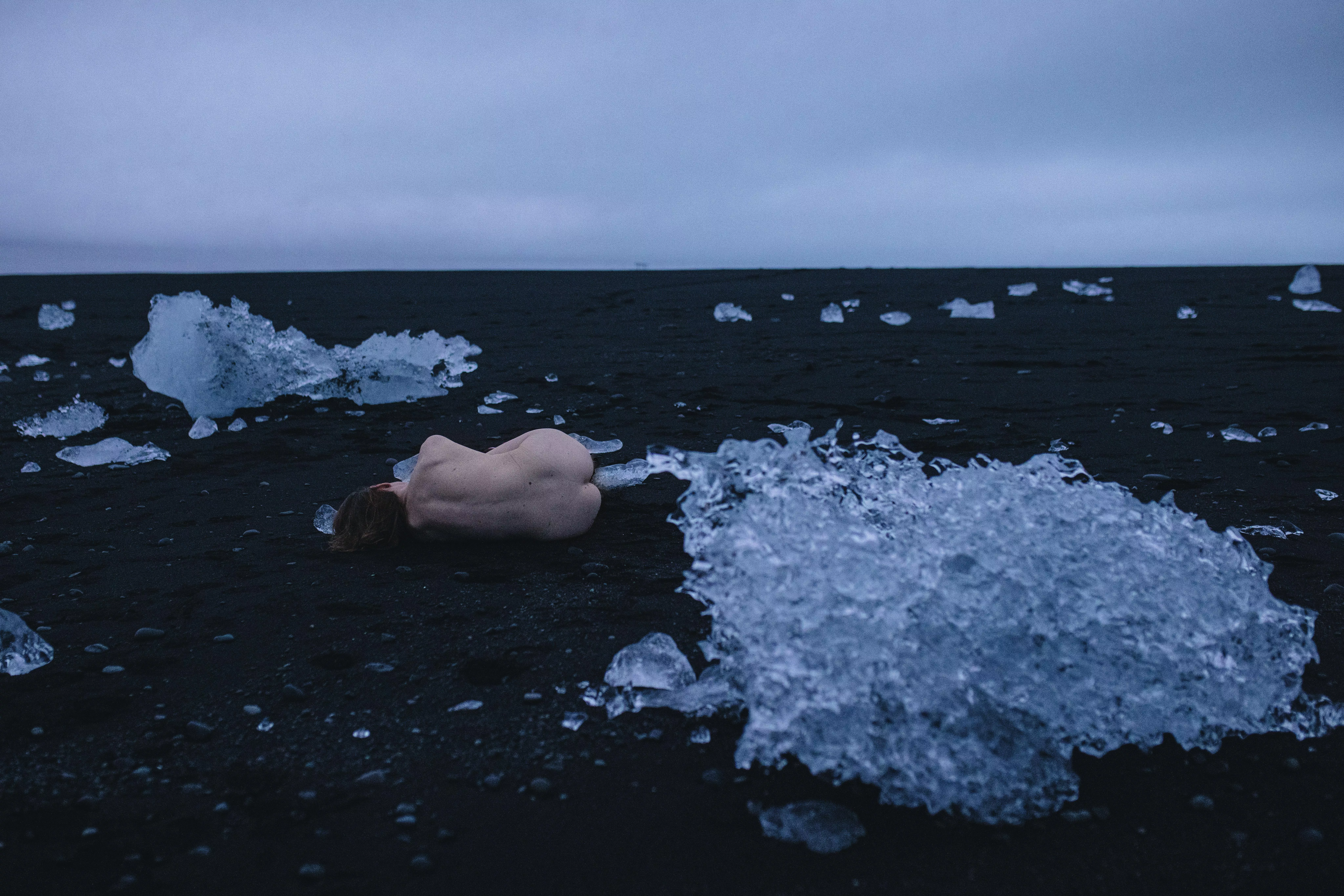 Alexandra Rachok by Anastasia Mihaylova - lying on the volcanic sand next to the ice floes