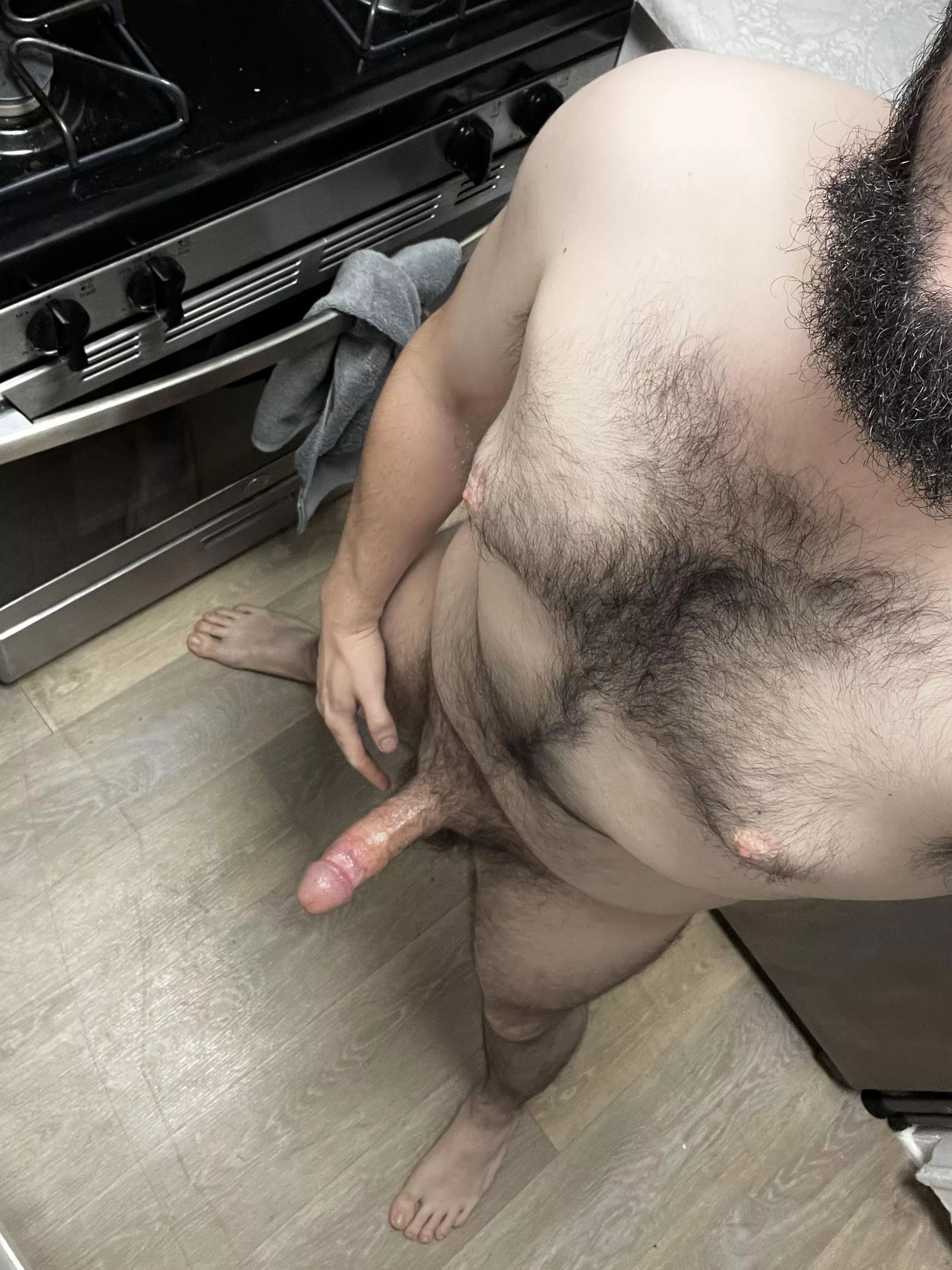 In the kitchen. Serving some sausage.