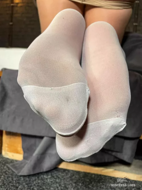 White stockings over flesh-colored pantyhose