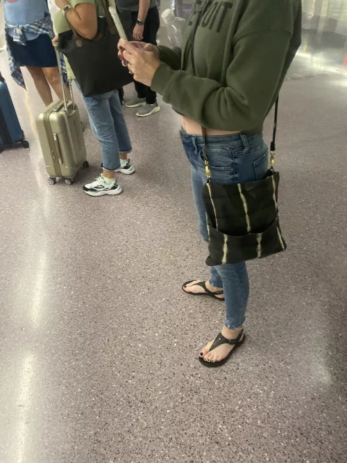 Is the baby bump peaking out as she awaits the train?