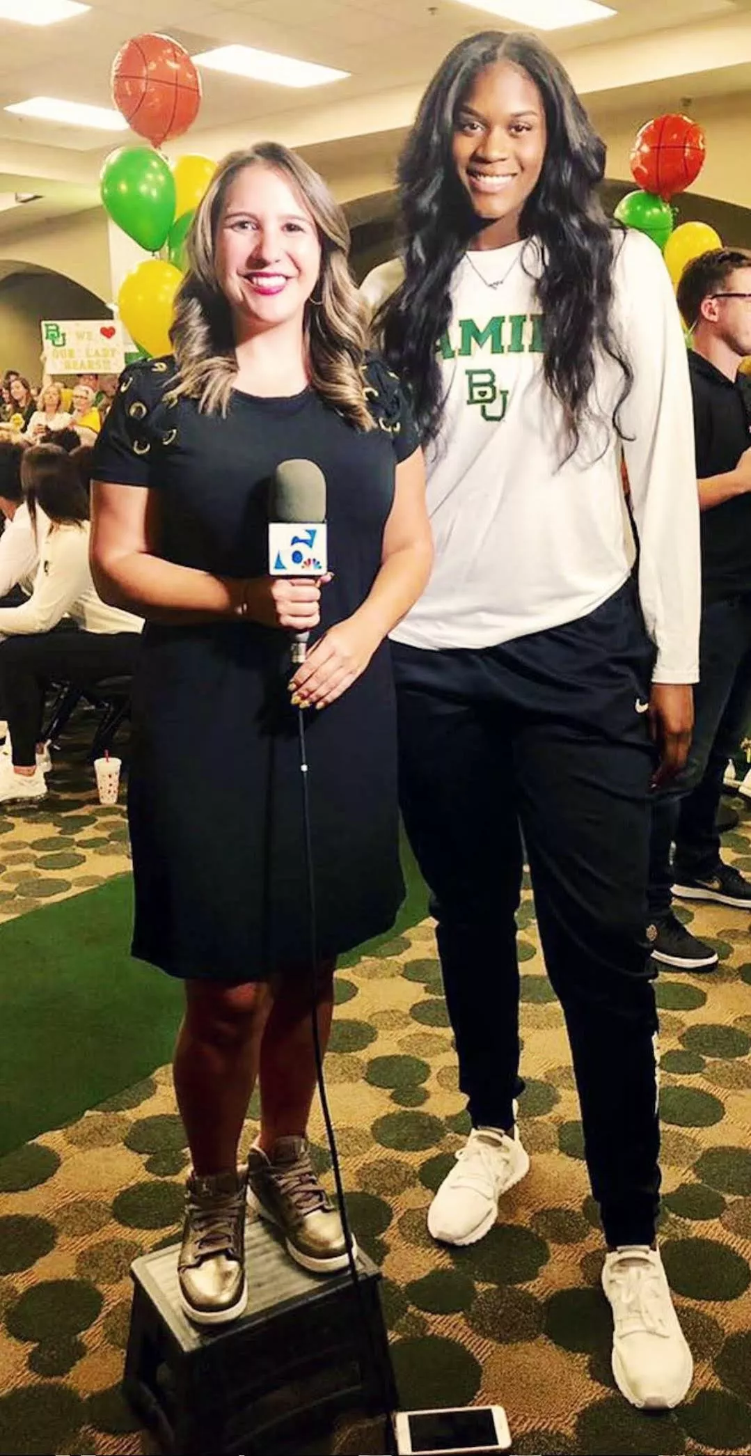 WNBA giantess Kalani Brown with a reporter