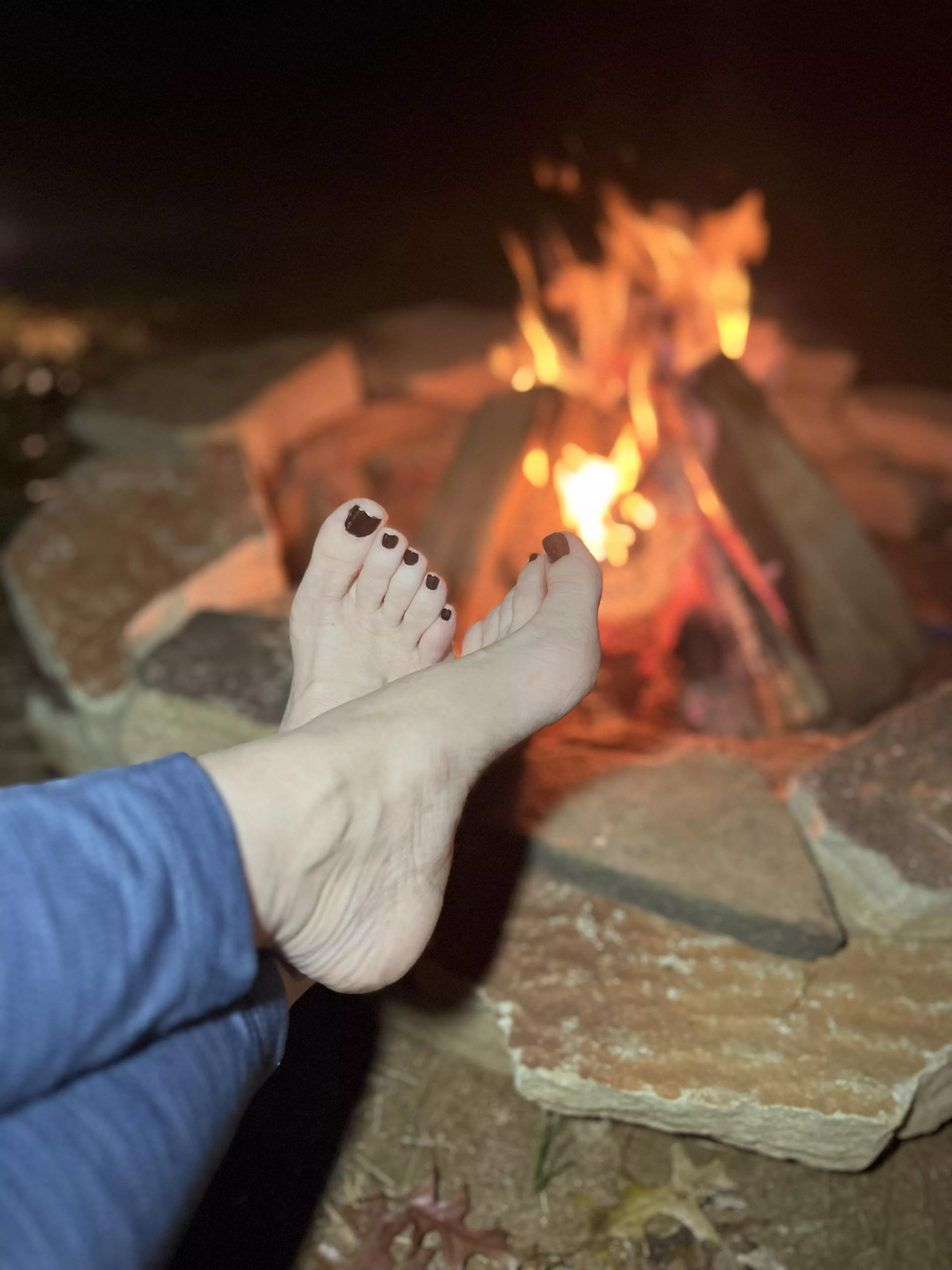 Keeping my feet warm by the campfire.