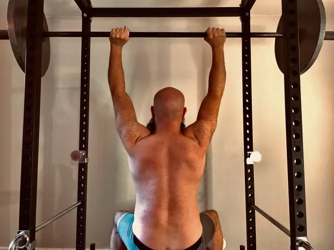 Narrator: The bald, portly and bearded male solicits compliments by lifting weights and posting on the internet.