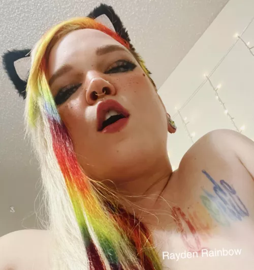 Rainbow hair on tattooed and pierced girl