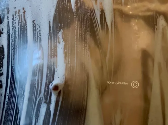 Just a nipple touching the glass in the shower.