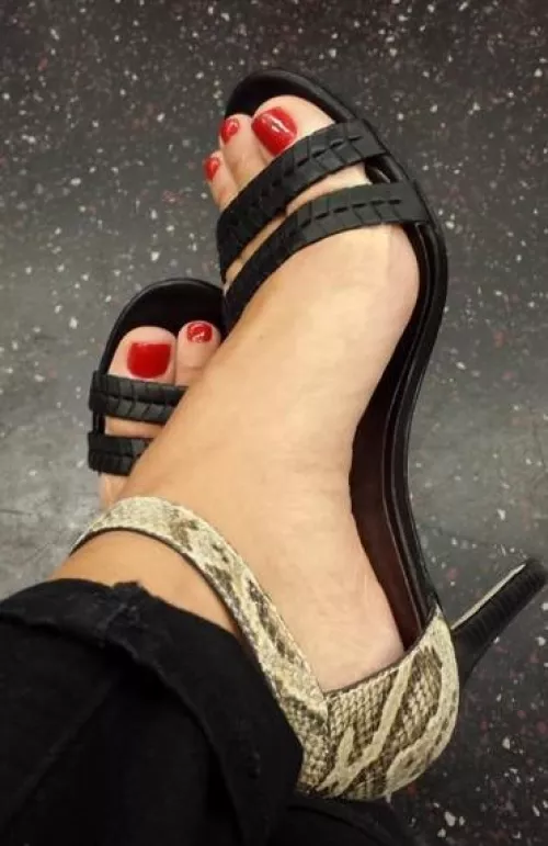 Red pedicured toes in high heel sandals