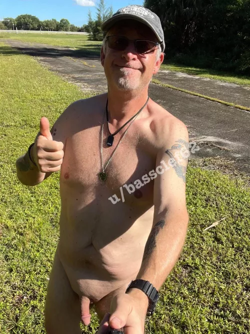 Naked and outside enjoying the beautiful sun! Really cool horse training track way behind me.