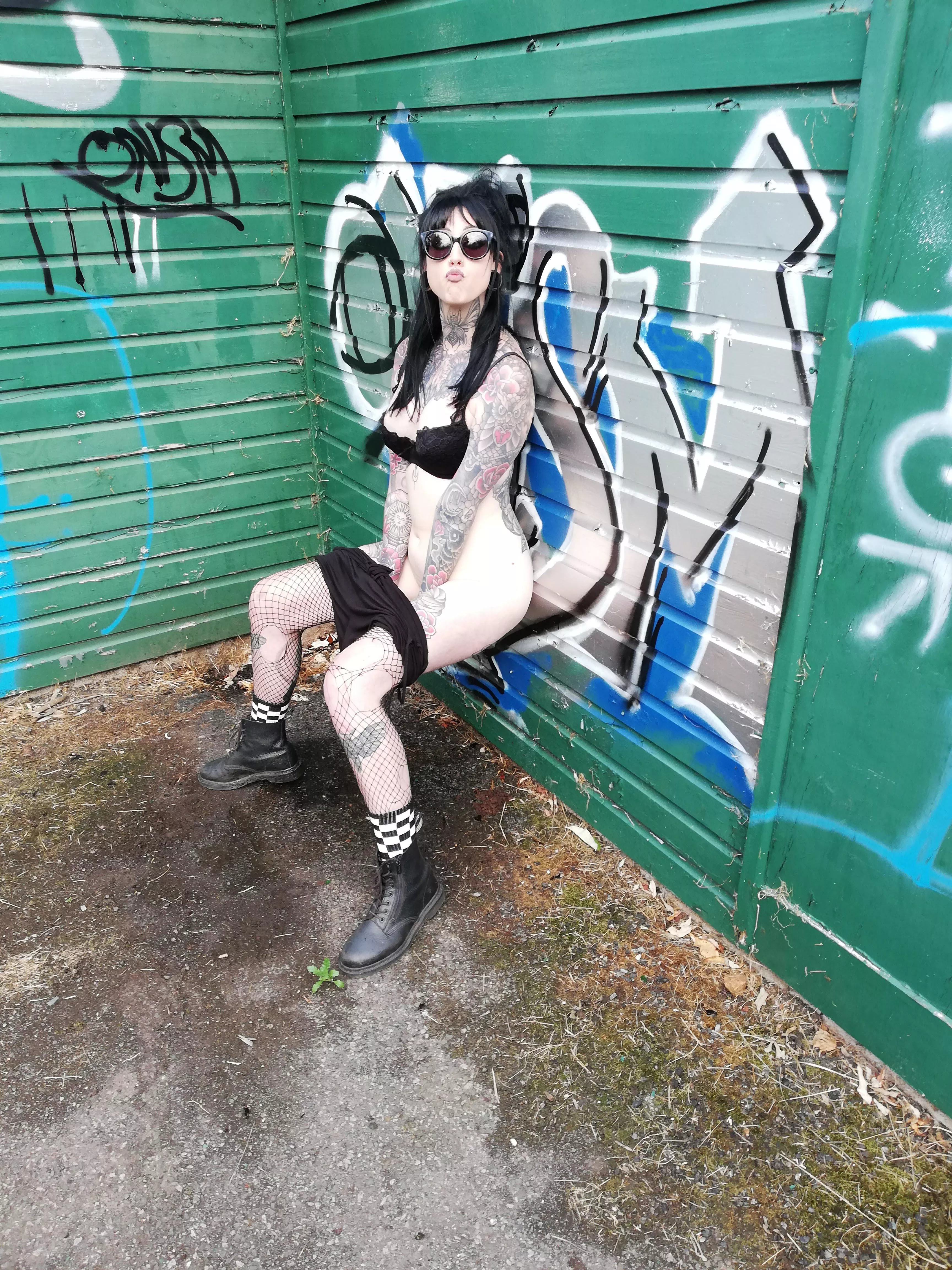 behind the hut with a playsuit on