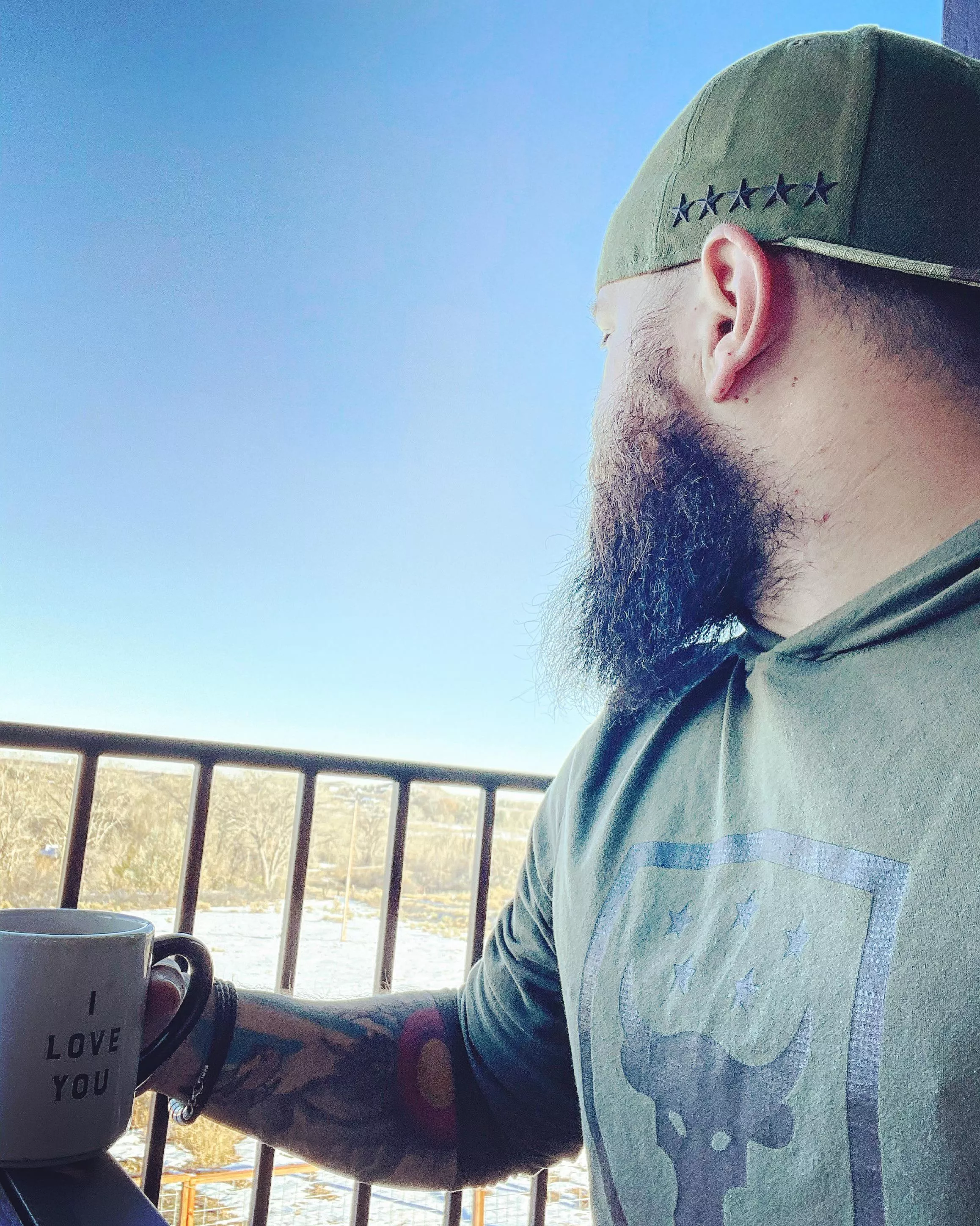 Beard, tattoos, coffee and a view