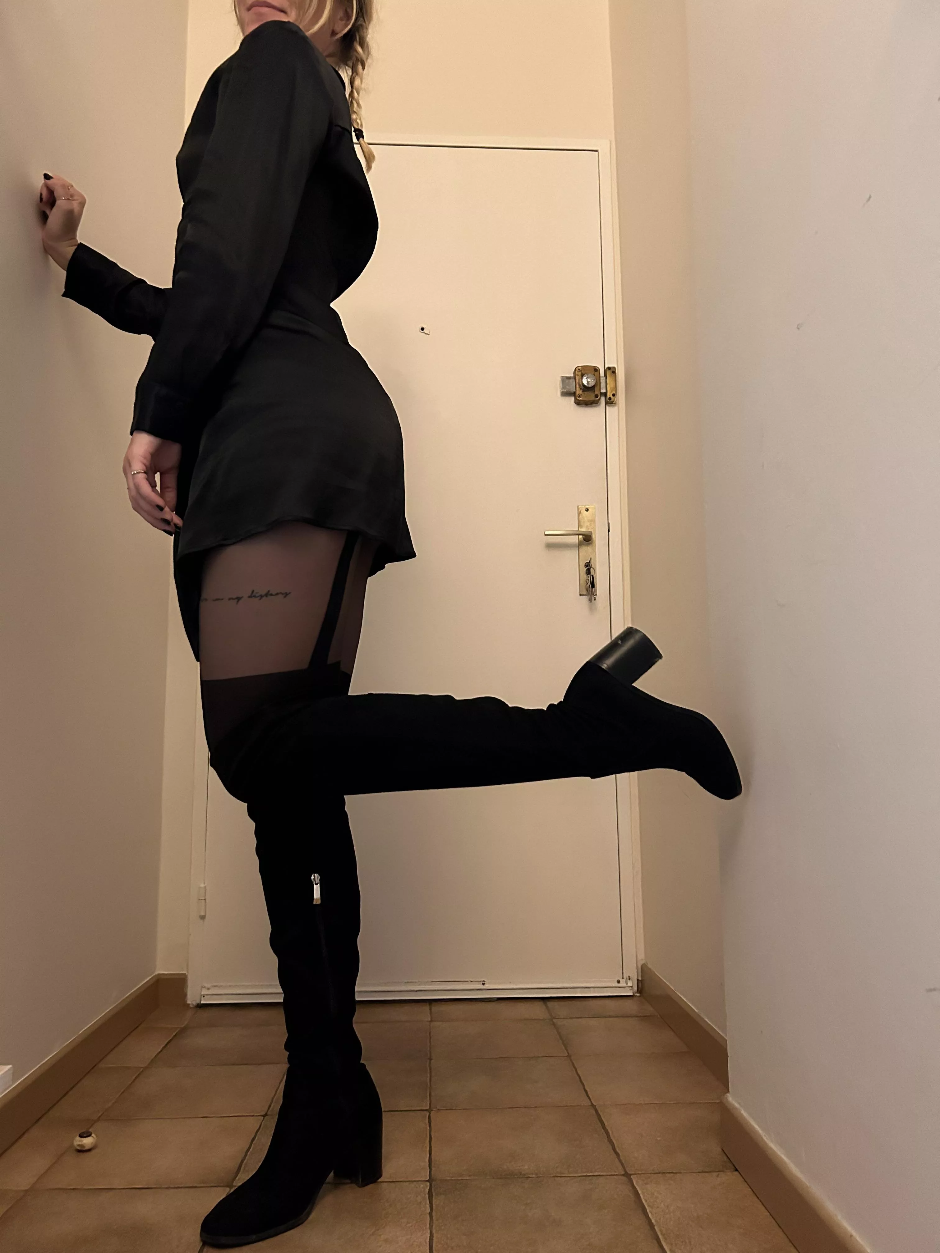 Black boots, black stockings and black dress