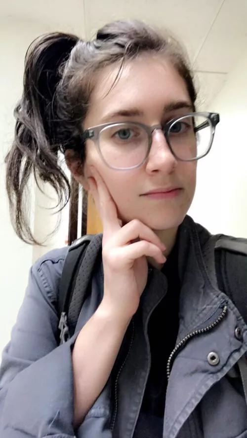 Pensive fully clothed girl with glasses