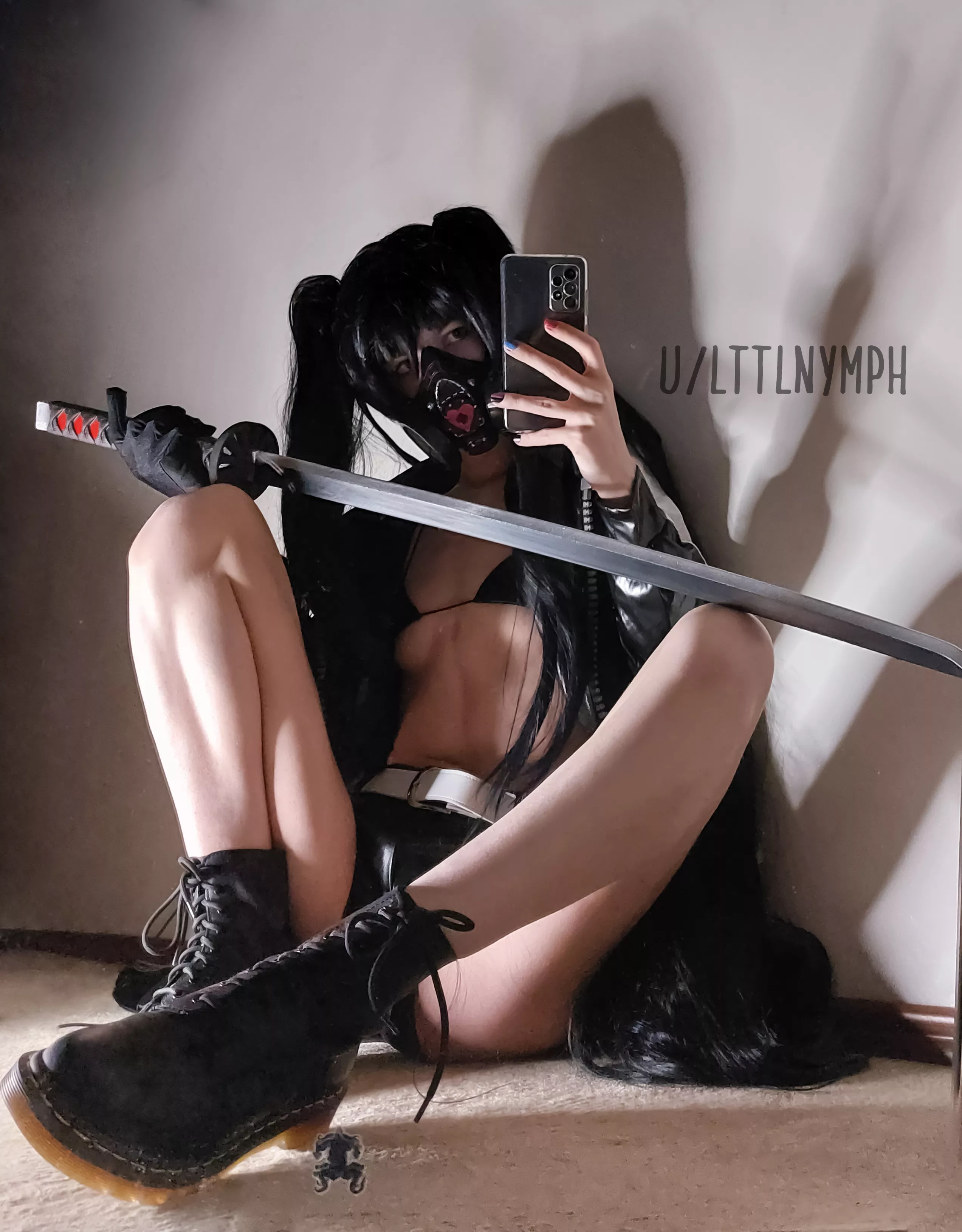 sitting with a prop katana
