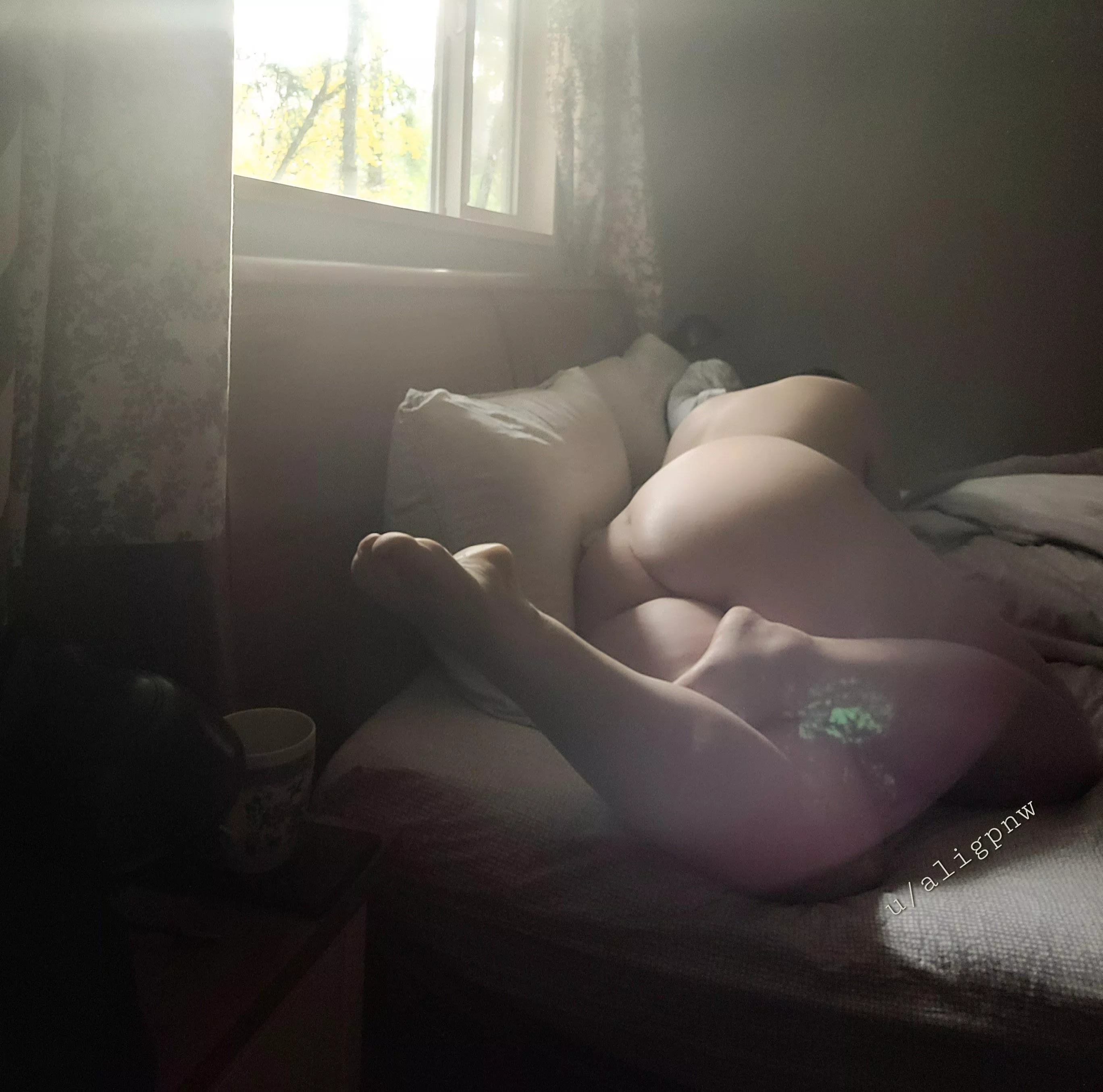 Reclining nude with coffee cup.