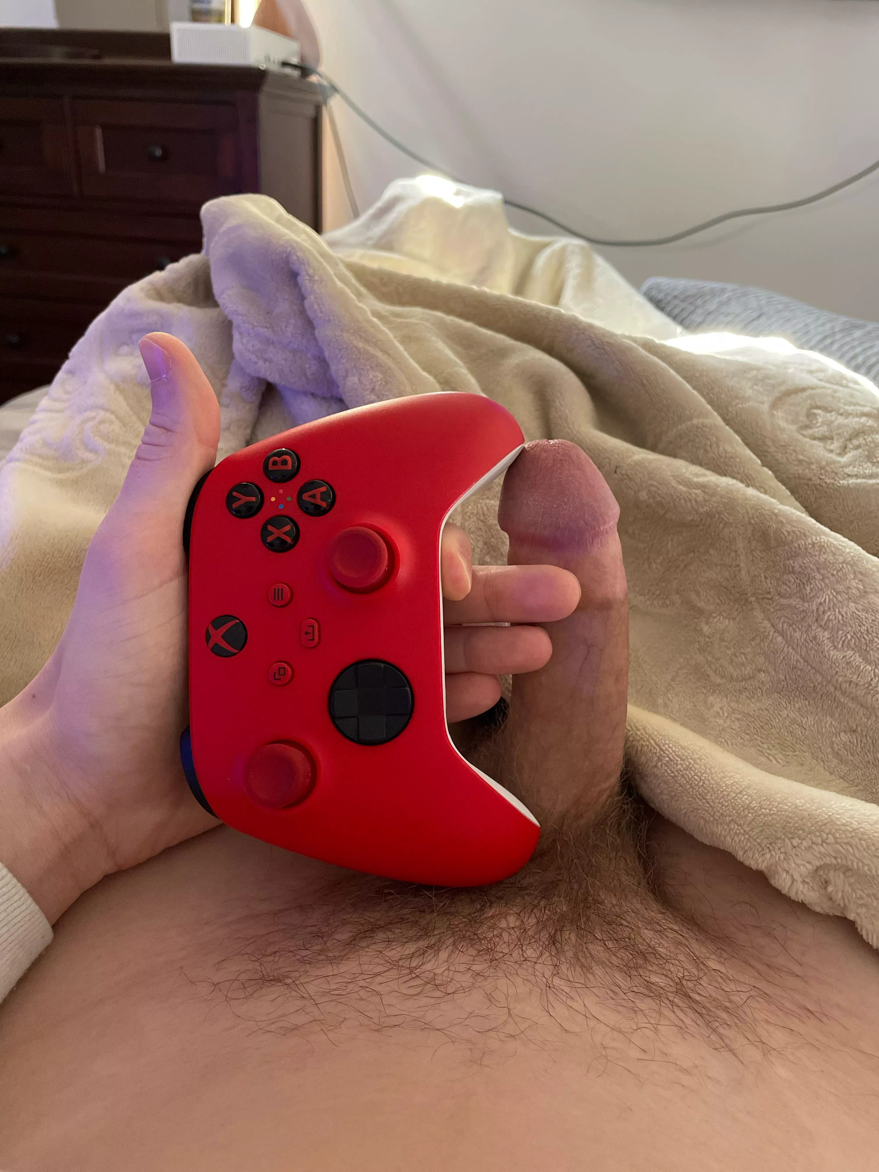 Next to an Xbox remote