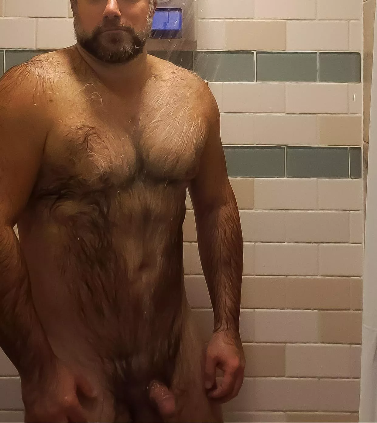 Does anyone appreciate peeking in on this older guy in the gym shower?