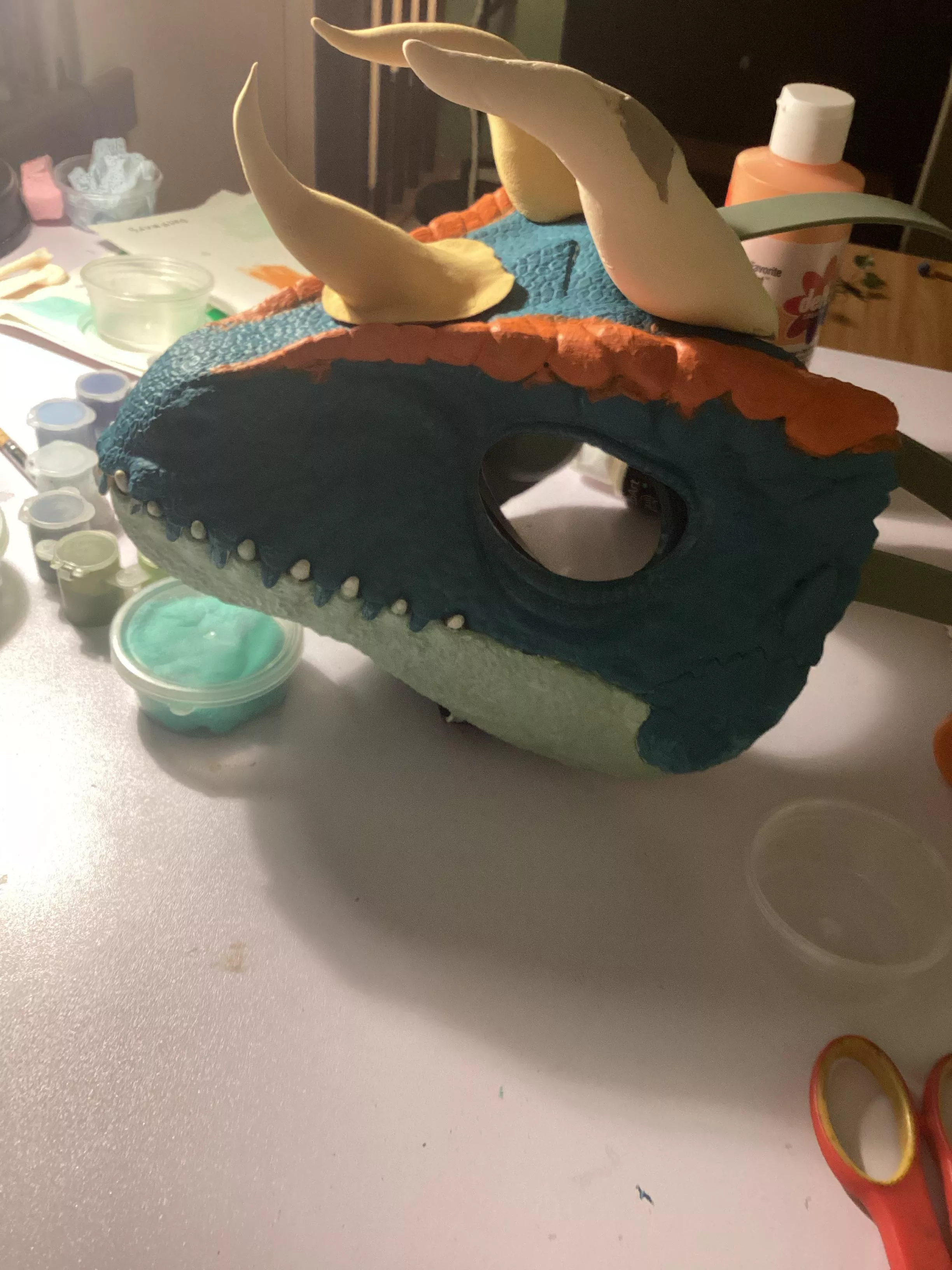 Working on a dinomask, where should I add horns?