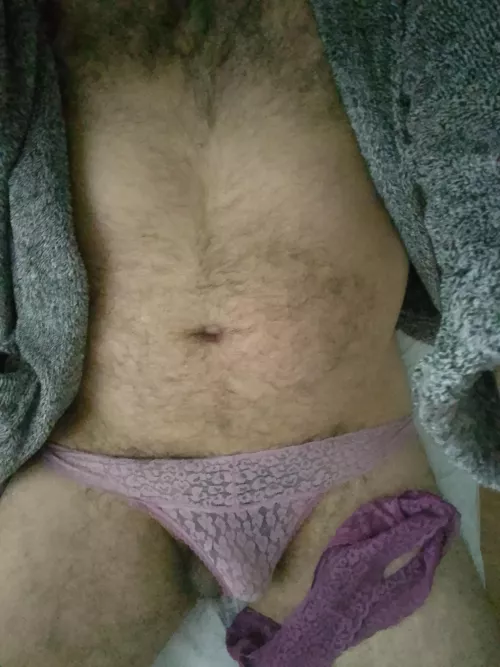 Wearing one rubbing with the other while laying in her bed