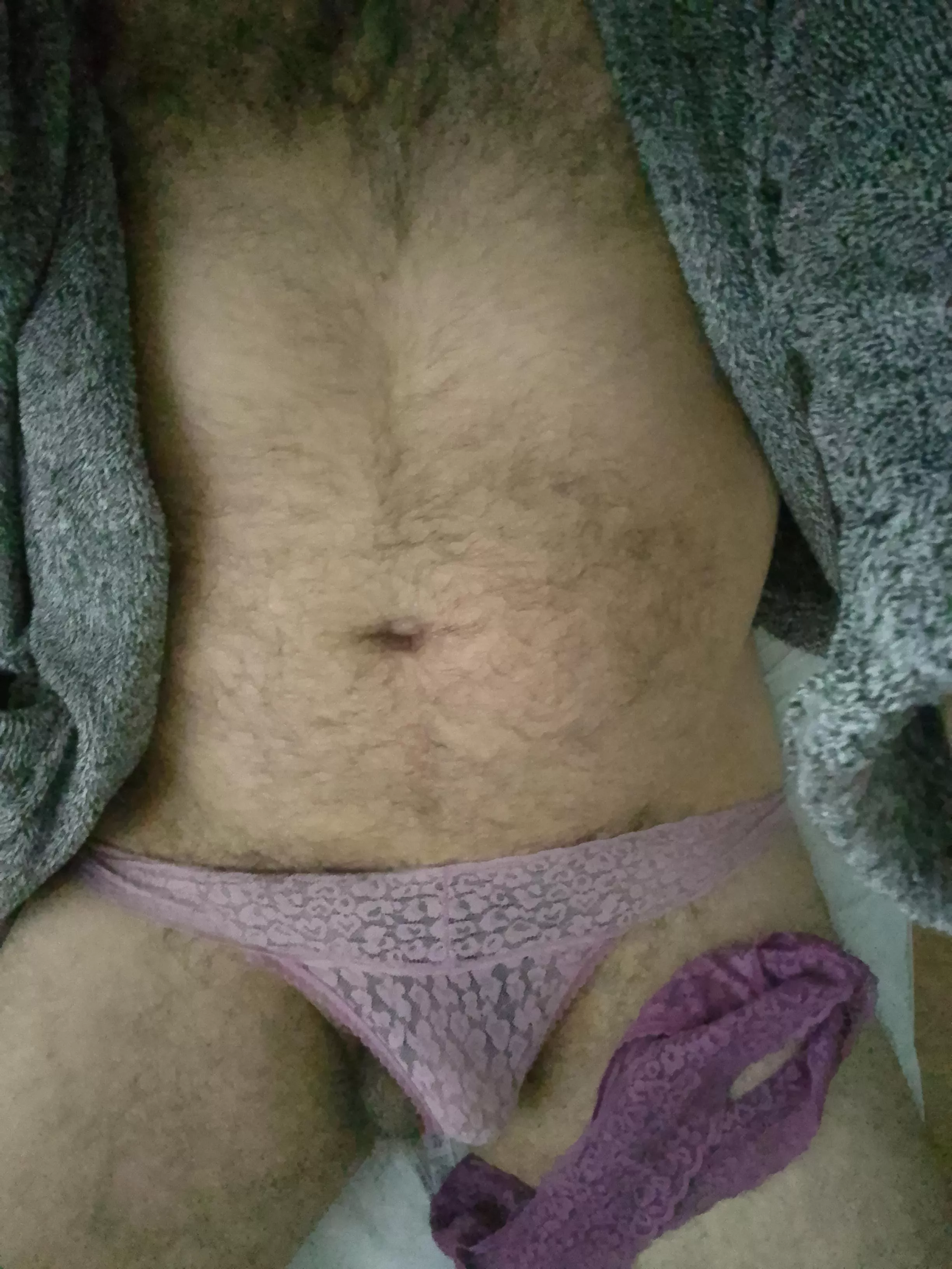 Wearing one rubbing with the other while laying in her bed