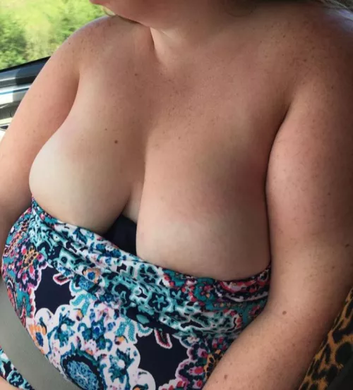 wife's cleavage trying to bust out on a road trip