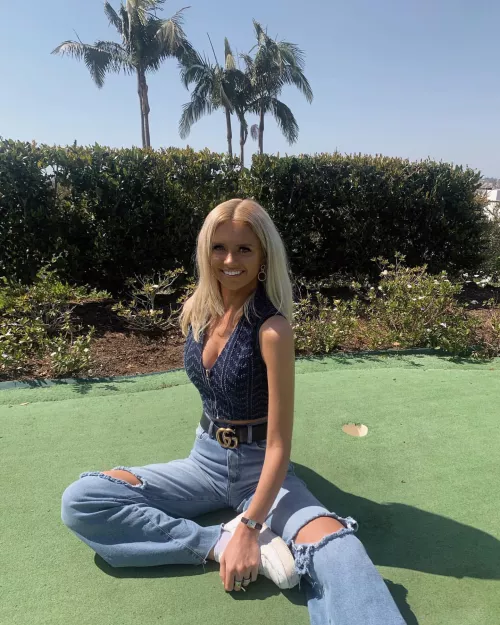 Sitting on a putting green.