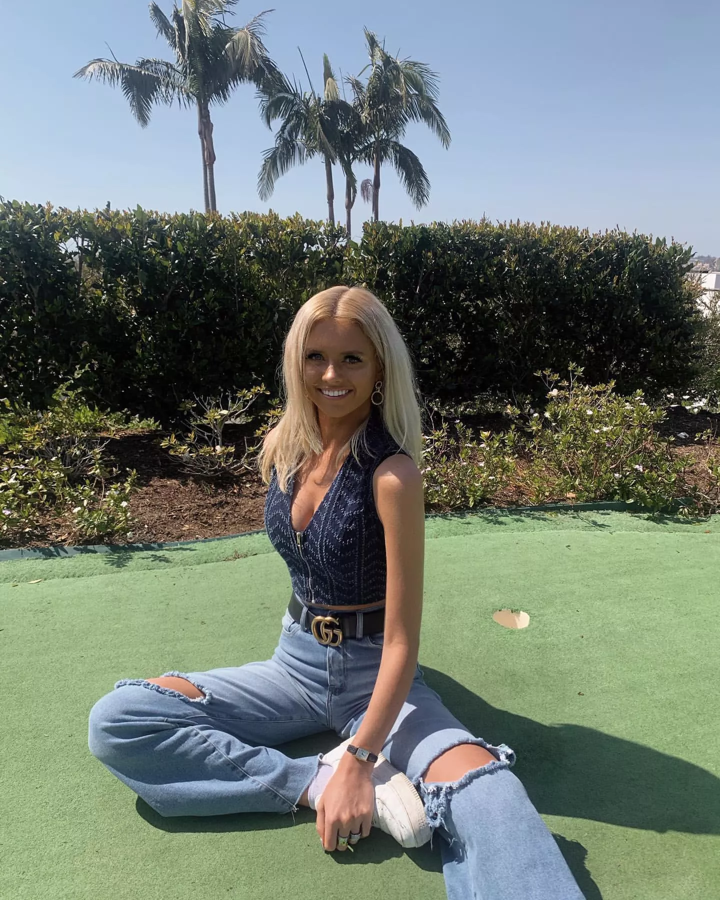 Sitting on a putting green.