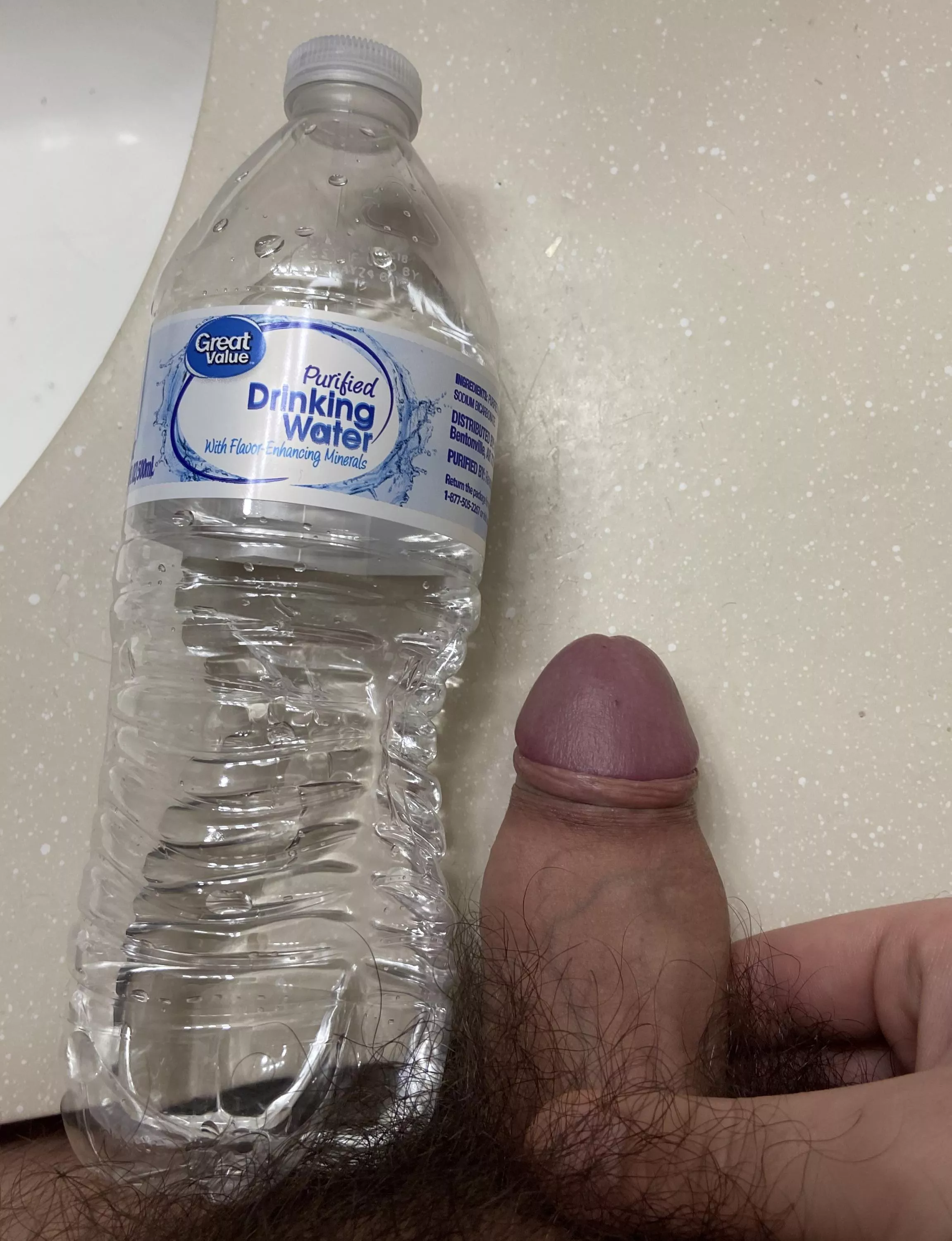 My cock next to a water bottle.
