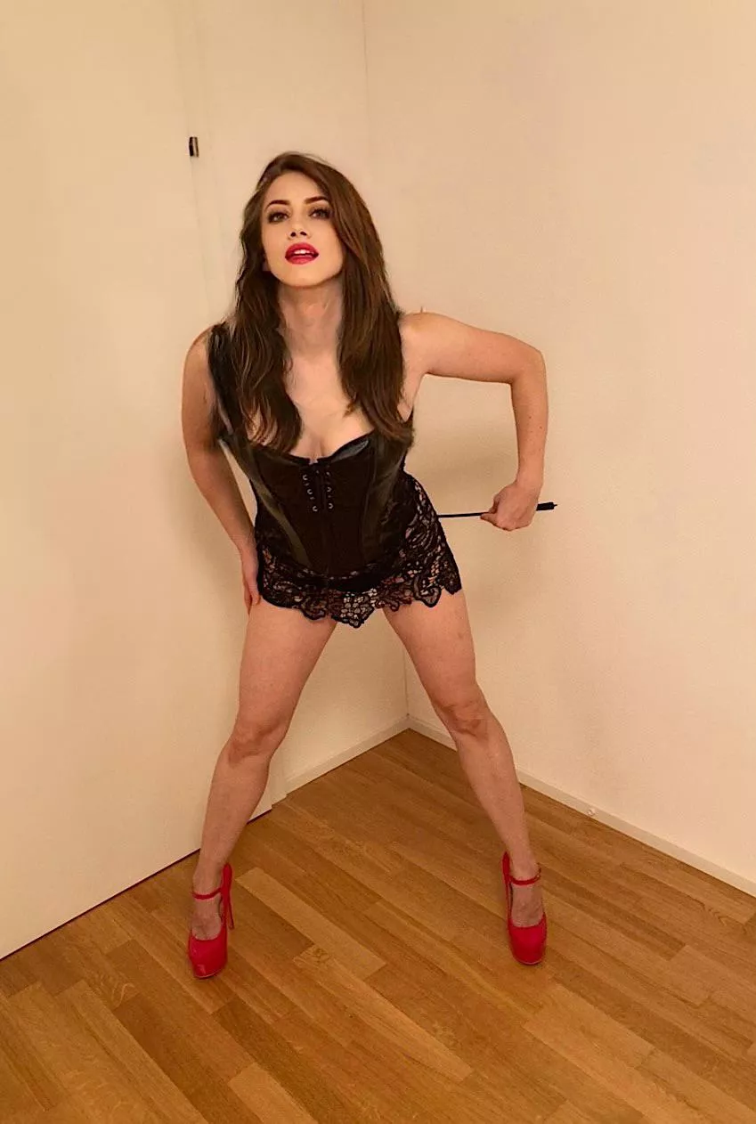 Black leather corset and red heels