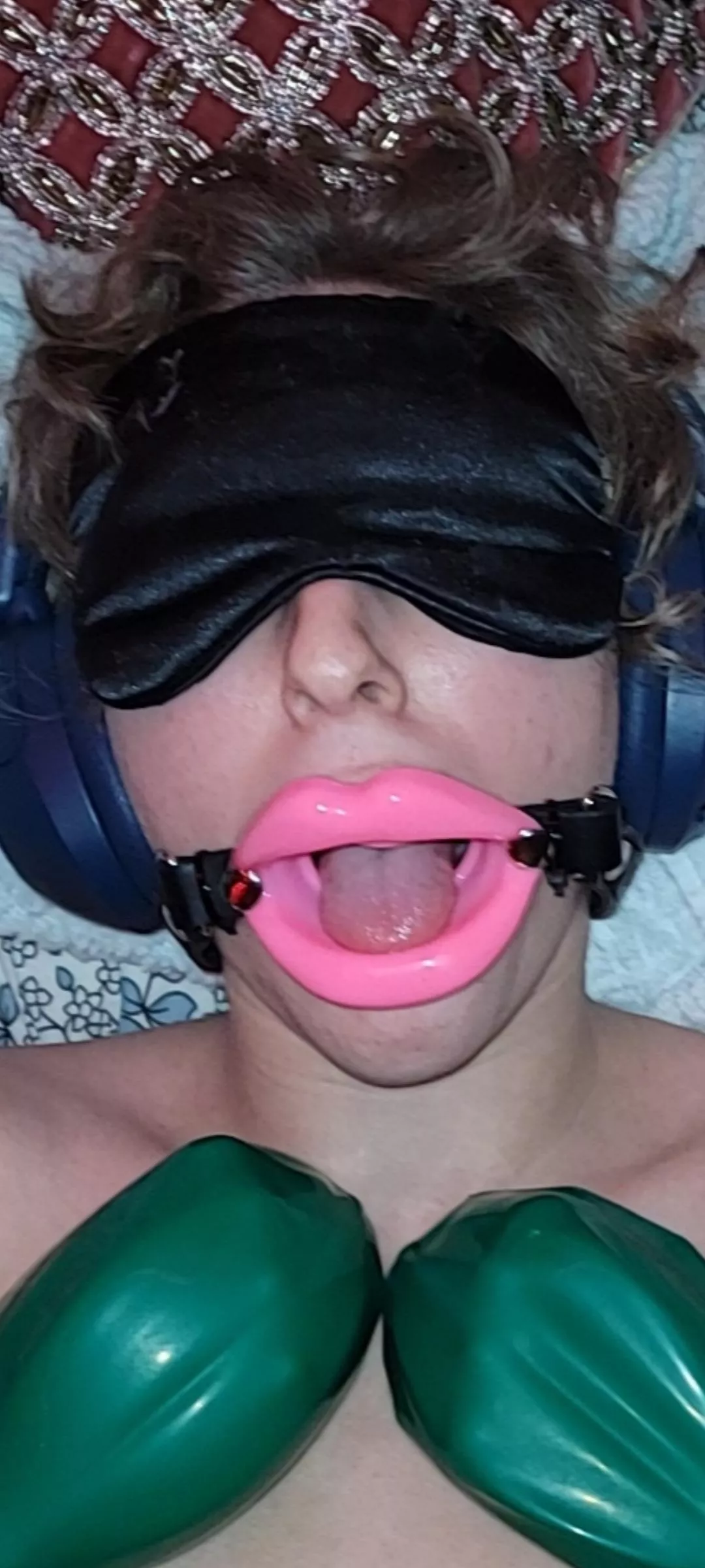 Listening to brainwashing audios with rubber mittens on