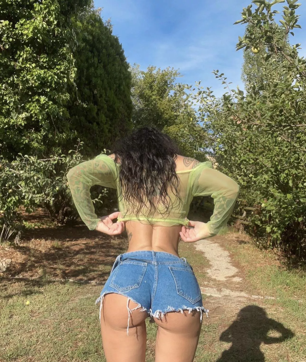 Sheer top and tight ripped jeans