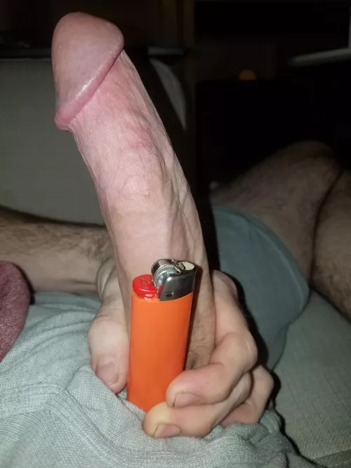 Regular sized lighter, not so regular sized cock...