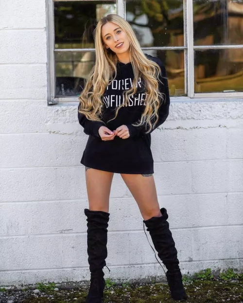 Black boots a black shirt and nothing else