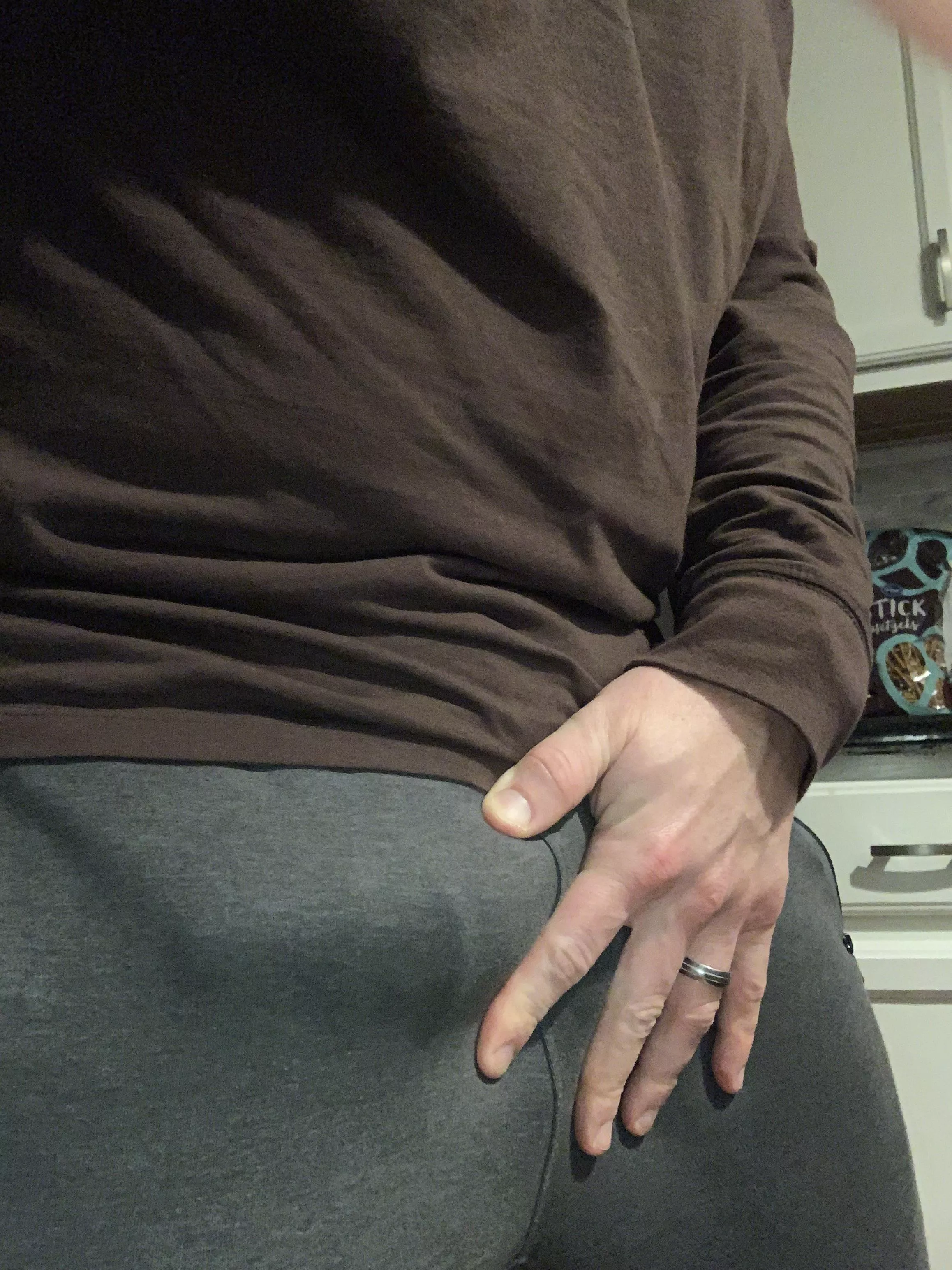 A subtle gray sweatpants bulge