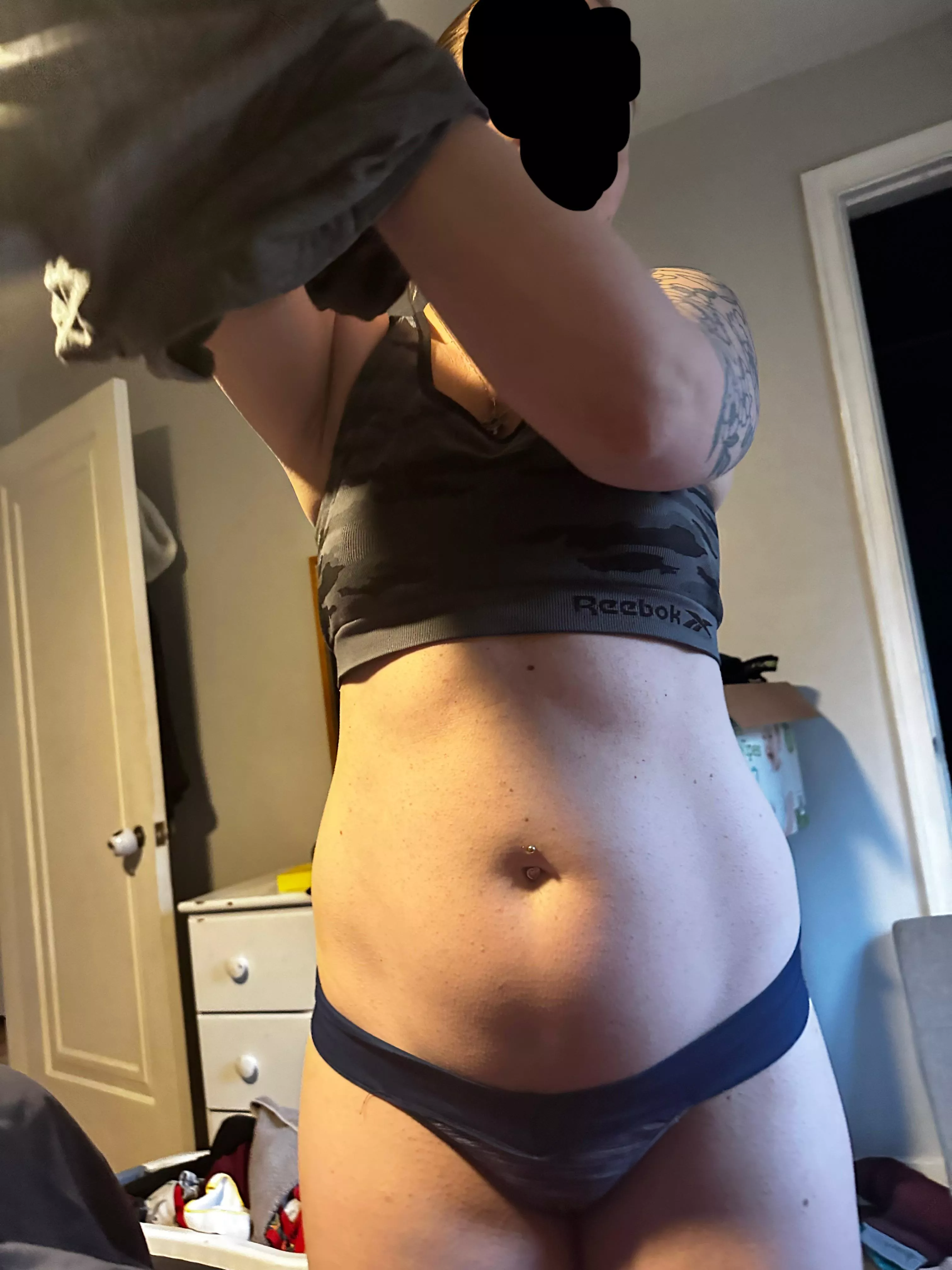 Pregnant nurse wife getting dressed