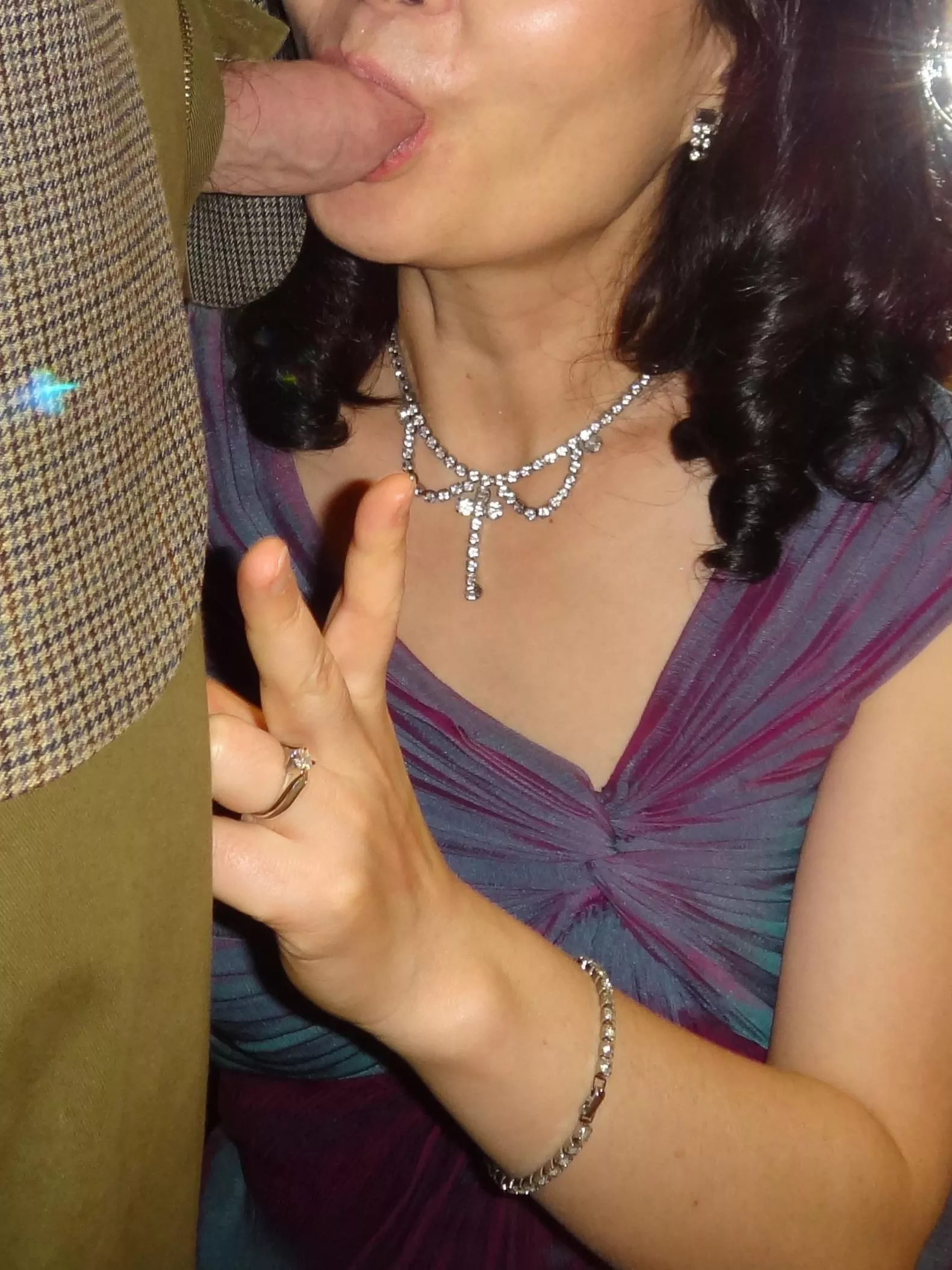 Wife entertains guest at holiday party