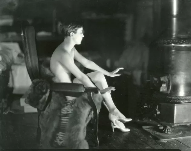 Bessie Love in 1925. Love was in Paris doing a photoshoot for Vogue Magazine. She was between costumes warming herself by an iron stove when the photographer snapped this image.