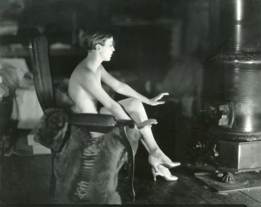 Bessie Love in 1925. Love was in Paris doing a photoshoot for Vogue Magazine. She was between costumes warming herself by an iron stove when the photographer snapped this image.