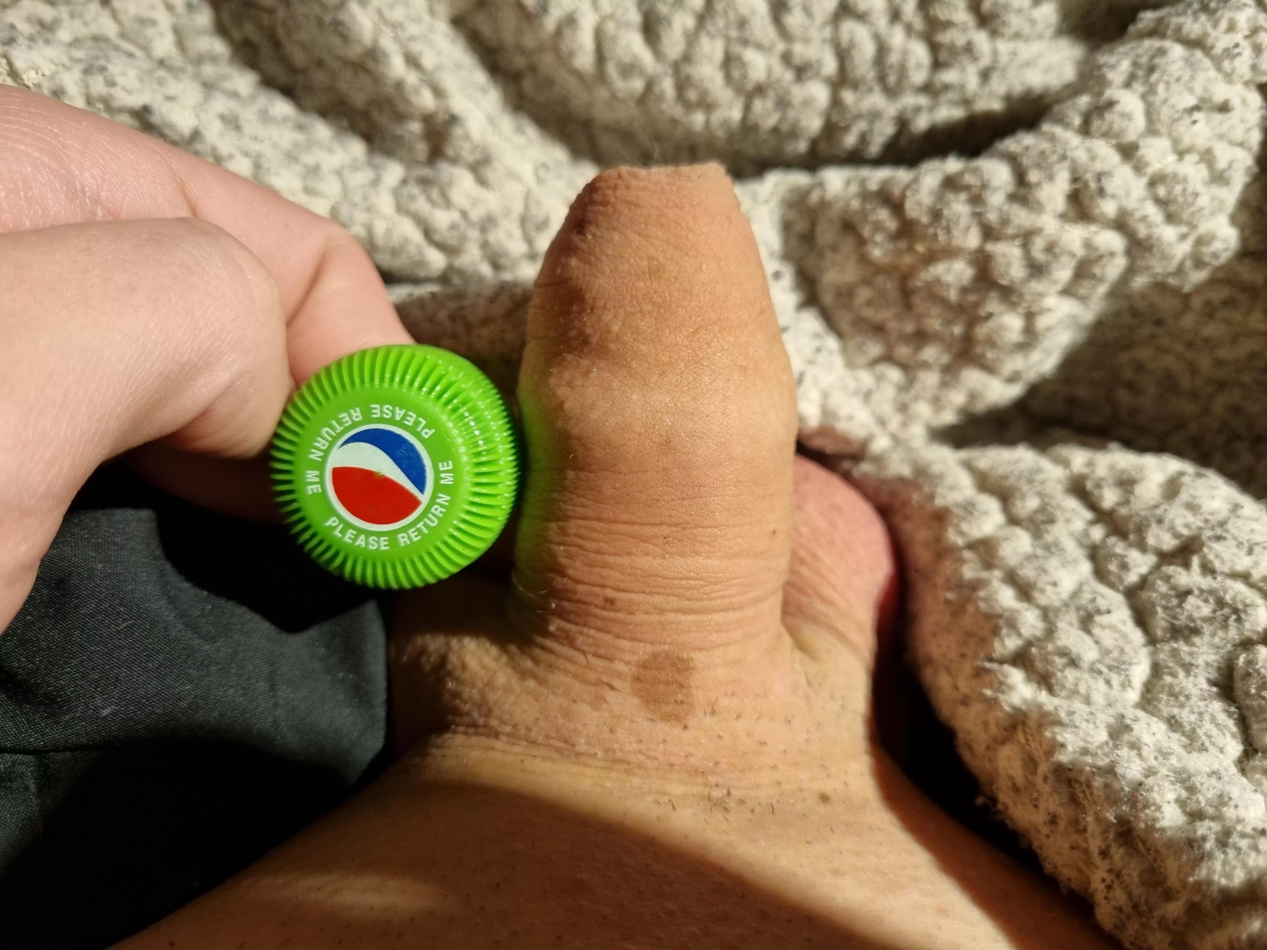 Softie Next to a Bottle Cap