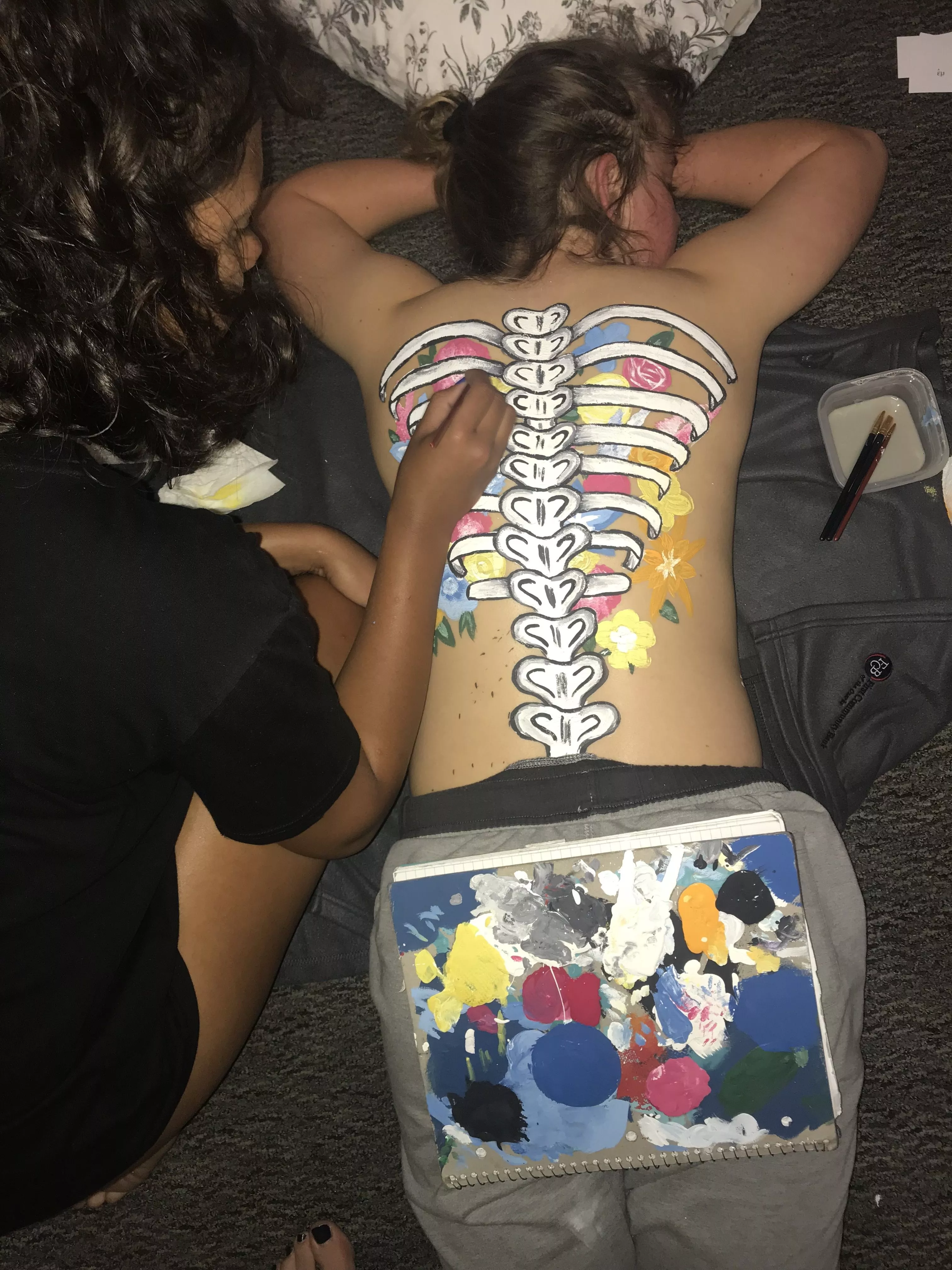 Just friends painting on each other's backs